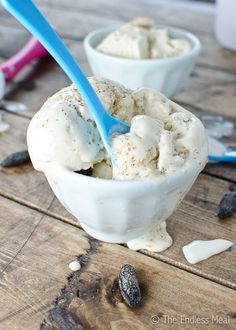 two bowls filled with ice cream on top of a wooden table