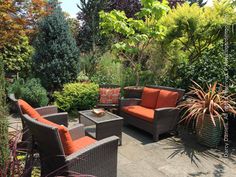 an outdoor seating area with wicker furniture