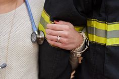 two people wearing rings and bracelets are holding each other's hands with a stethoscope on their wrist