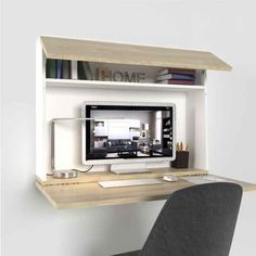 a computer monitor sitting on top of a wooden desk next to a chair and book shelf