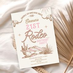 a birthday party card sitting on top of a bed next to some straws and palm leaves