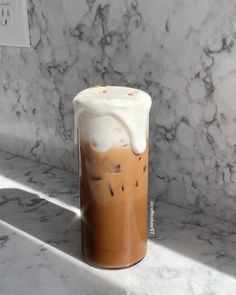 an iced drink is sitting on a marble counter