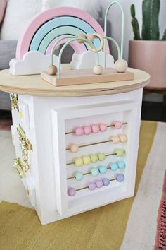 a toy carousel with wooden pegs and pastel colors