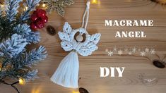 an angel ornament hanging from a string on a wooden table with christmas lights