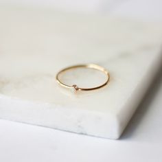 "This beautifully dainty ring is the perfect gemstone stacker! They make wonderful gifts for mothers as you can easily stack multiples, one for each loved one. They also make delicate little promise rings! We can make these in 14k gold filled, 14k rose gold filled, sterling silver, solid 14k yellow gold or solid 14k rose gold. You are also able to customize your ring size at checkout. The A-Grade Australian Opal measures 2mm across. This listing is for (1) opal ring (October's Birthstone), but w Minimalist Tiny Stackable Promise Rings, Everyday Minimalist Stackable Crystal Ring, Minimalist Stackable Crystal Ring For Everyday, Minimalist Yellow Gold Opal Ring, Dainty Yellow Gold Stackable Opal Ring, Dainty Crystal Birthstone Ring, Dainty Everyday Moonstone Ring, Minimalist Everyday Crystal Ring, Minimalist 14k Gold Moonstone Birthstone Ring