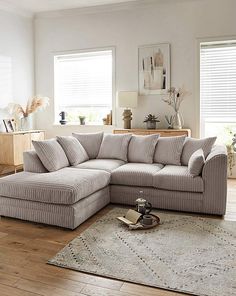 a living room with a sectional couch and rug