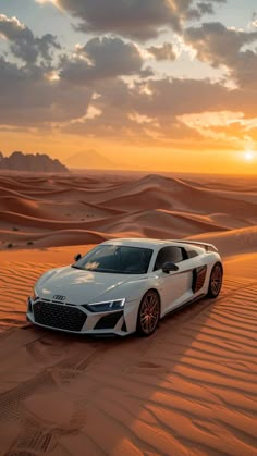 a white sports car in the middle of desert sand dunes at sunset with clouds overhead