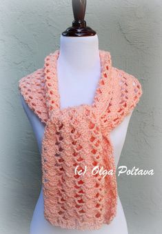 a crocheted shawl is shown on a mannequin