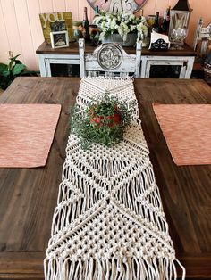 the table runner is decorated with flowers and greenery on it, along with other place mats