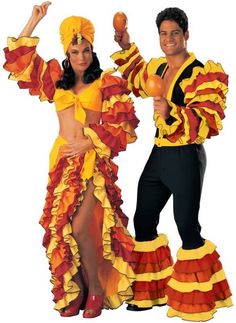 two people dressed in colorful costumes posing for a photo with an orange and yellow outfit