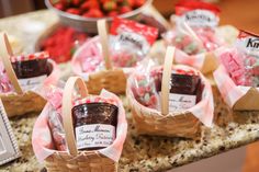 small baskets filled with jams and strawberries on a counter