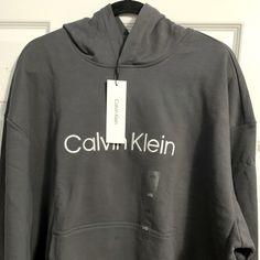 New With Tags Gray Calvin Klein Hooded Cotton Sweater Logo Print Hoodie For Fall, Calvin Klein Cotton Hoodie For Fall, Calvin Klein Logo Print Sweatshirt For Fall, Calvin Klein Hooded Winter Sweatshirt, Calvin Klein Cotton Hoodie With Long Sleeves, Calvin Klein Hooded Sweatshirt For Fall, Calvin Klein Hooded Sweatshirt For Winter, Calvin Klein Hoodie Sweatshirt For Fall, Calvin Klein Hooded Hoodie For Fall