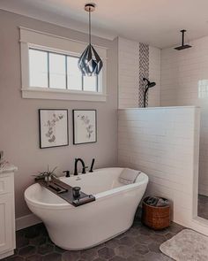 a white bath tub sitting next to a walk in shower