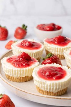 strawberry cheesecakes on a plate with fresh strawberries