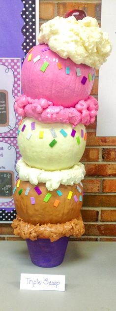 there is a large cupcake made out of ice cream and sprinkles