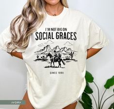 Not Big On Social Graces Shirt - 90s Country, Western Tee, Garth Shirt, Friends In Low Places Shirt, Country Lyrics, Garth Fan Gift, Concert ϟ High quality, direct-to-garment ink printed. ϟ ✦ Fit + Quality ✦ These UNISEX Comfort Colors tees are like a well-loved favorite - they wash well and are easy to wear. ✦ 100% ringspun cotton ✦ Preshrunk, soft-washed, garment-dyed fabric ✦ Twill taped shoulder-to-shoulder ✦ Set-in sleeves ✦ Double-needle stitched sleeves and bottom hem ✦ 1" ribbed collar with double-needle topstitched neckline Washing & Drying Instructions: ✦ Turn inside out. ✦ Wash with cold/warm water. ✦ Do not use bleach. ✦ Don't tumble dry - hang dry or lay flat to dry. ✦ Returns + Shipping ✦ My items are made to order - because of this, I am not accepting returns. If there are a Distressed Band Tee, Country Concert Shirts, Social Graces, Grace Shirts, Friends In Low Places, Country Girl Shirts, 90s Country, Country Bands, Country Lyrics