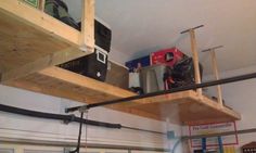 there is a garage with some tools on the shelf and other things hanging from the ceiling