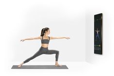 a woman is doing yoga in front of a poster