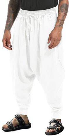 PRICES MAY VARY. These harem pants features 2 side pockets, offering both functionality and style. The drop crotch design of these wide leg pants adds a trendy and relaxed look. This leisure harem trouser features with elastic waist with adjustable drawstring to give you the maximum comfort at the waist, drop crotch design for ease of movement. The casual harem pants made of high quality cotton material, soft, breathable, skin-friendly, lightweight and moisture-wicking, keep you cool and relaxed all the time. Perfect for Halloween, dance, streetwear, ninja pants,cosplay,lounging around the house, or in the park, Suitable for wearing in the all seasons. Machine wash in cold water, don't bleach. Please refer to our SIZE CHART before ordering. With an elastic wide waistband for a perfect fit, Dance Streetwear, Ninja Pants, Halloween Dance, Casual Linen Pants, Harem Trousers, Drop Crotch Pants, Pants Baggy, Mens Casual, Mens Pants Casual