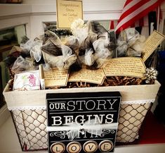 a basket filled with lots of books on top of a table next to an american flag