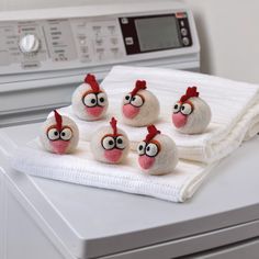 five chicken rocks sitting on top of a washing machine