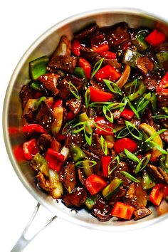 a pan filled with stir fry vegetables on top of a table