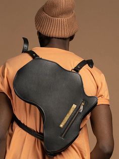 Africa Bag / Backpack - Black Leather (Large) - SHOP | Orijin Culture Black Leather Chest Bag For Travel, Black Leather Chest Bag Backpack, Modern Black Leather Backpack With Luggage Sleeve, Modern Black Leather Crossbody Backpack, Black Shoulder Bag With Leather Backing For Everyday Carry, Modern Black Leather Shoulder Backpack, Black Leather Backpack Shoulder Bag, Black Leather-backed Shoulder Bag Backpack, Modern Black Leather Backpack With Zipper Pocket