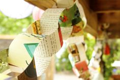 several pieces of paper hanging from a wooden structure