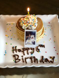 a birthday cake on a plate with a candle