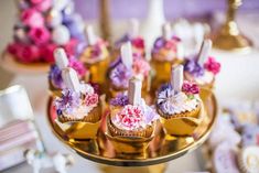 cupcakes on a gold plate with pink and purple flowers