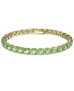 Embracing the contemporary fluidity of the Matrix Tennis family, this glittering bracelet surrounds your wrist in vibrant light-reflecting color. Round green stones are set in gold-tone plating in sleek uniformity, giving you a piece of jewelry that is striking enough to be worn alone, and simple enough to be styled with other pieces.Size: L Luxury Green Bracelet With Polished Finish, Luxury Green Tennis Bracelet For Formal Events, Luxury Green Tennis Bracelet, Elegant Green Tennis Bracelet For Party, Luxury Green Bracelets For May Birthstone, Luxury Green Bracelet For May Birthstone, Luxury Green Round Tennis Bracelet, Green Bangle Tennis Bracelet For Formal Occasions, Green Formal Tennis Bangle Bracelet