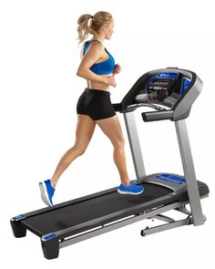 a woman running on a treadmill