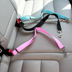 a pink and blue leash attached to the back of a car seat in a vehicle