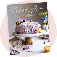 the cover of baked with love, featuring a cake on a white plate and flowers