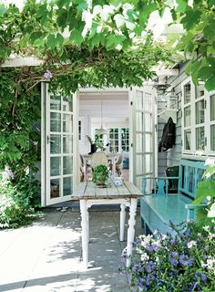 an outdoor dining area with table, chairs and potted plants