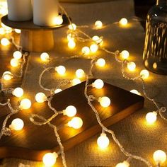 a table topped with candles and string lights