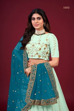 This Green Faux Georgette Lehenga Choli Set with Dupatta is adorned with intricate Zari, Thread & Sequins Embroidery, giving it a timeless and classic look. It includes a 3.5 Meter-long lehenga, a blouse with Regular Sleeves and a 2.30 Meter-long dupatta. The fabric is extra-soft and can be customized to your measurements. Washing instructions: Dry Clean. No of Set - 3-piece set Color- Green Lehenga Choli Fabric - Faux Georgette Stitch Type - Semi-Stitched (Standard Cancan & Canvas Attached) Fla Festive Pista Green Blouse Piece With Intricate Embroidery, Embroidered Pista Green Georgette Choli, Pista Green Choli With Intricate Embroidery For Festive Occasions, Festive Embroidered Georgette Lehenga, Fitted Pista Green Embroidered Fabric For Diwali, Semi-stitched Pista Green Choli With Intricate Embroidery, Pista Green Choli With Intricate Embroidery For Festive, Pista Green Embroidered Choli For Festive Occasions, Embroidered Pista Green Sets For Reception