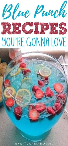 blue punch recipe in a bowl with strawberries and lemons