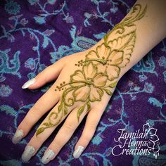 a woman's hand with henna tattoos on it