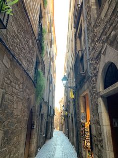 an alley way with stone buildings and cobblestone streets