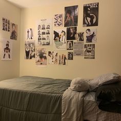 a bed sitting in a bedroom next to a wall with pictures on it