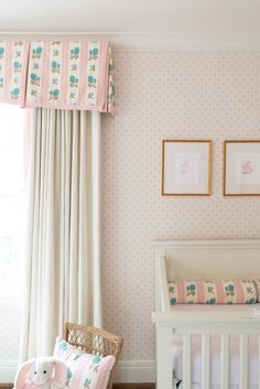 a baby's room with pink and white decor