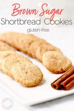 brown sugar shortbread cookies on a white plate with cinnamon sticks