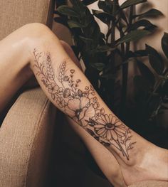 a woman's leg with flowers on it