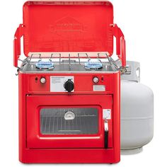 a red stove top oven sitting next to a propane tank on a white background