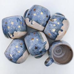 five blue and white ceramic vases with stars on them