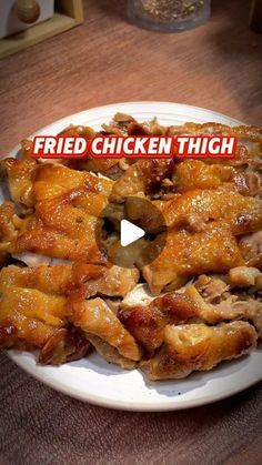 fried chicken thighs on a white plate with the words fried chicken thigh over it