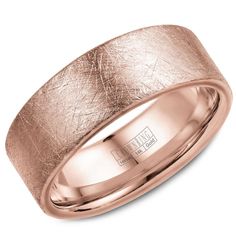 a rose gold wedding ring with an etched design