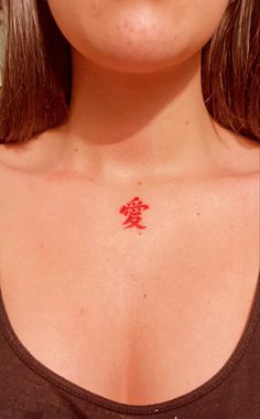 a woman with a red tattoo on her chest