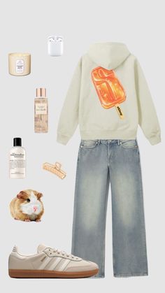 the contents of a woman's outfit including an orange ice cream cone sweatshirt, jeans and sneakers